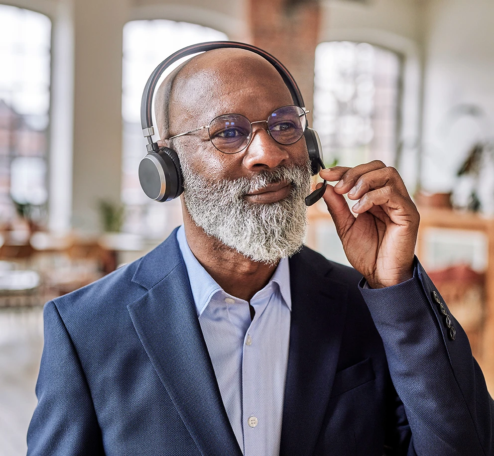 a-man-speaking-on-a-headset.webp