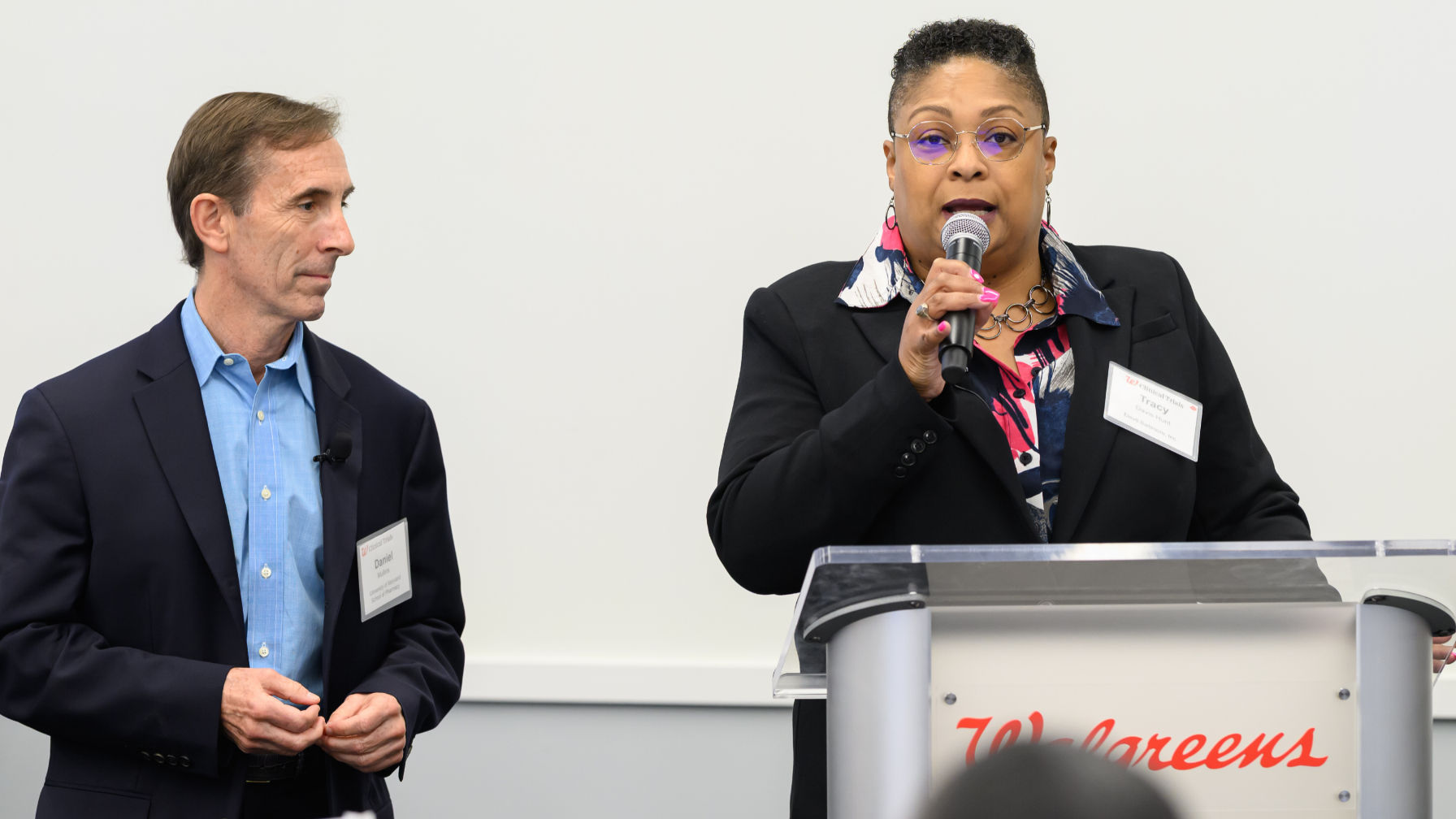 Rev. Tracy Davis Hunt, associate minister, Mt. Lebanon Baptist Church, speaks at the podium with C. Daniel Mullins, University of Maryland School of Pharmacy professor.