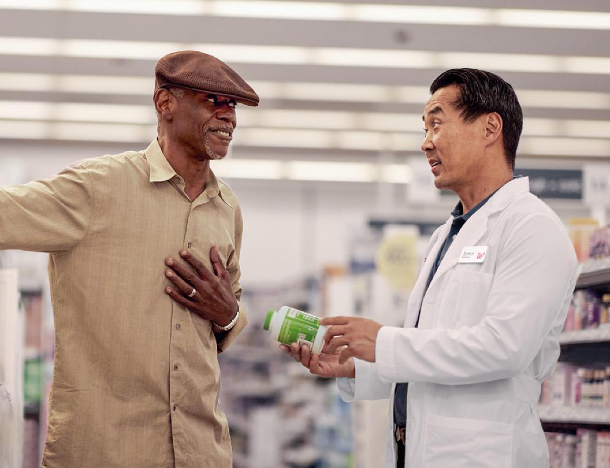 Pharmacist talking to an elderly gentleman