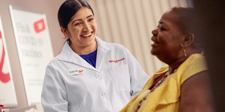 Young Pharmacist smiling with a Patient
