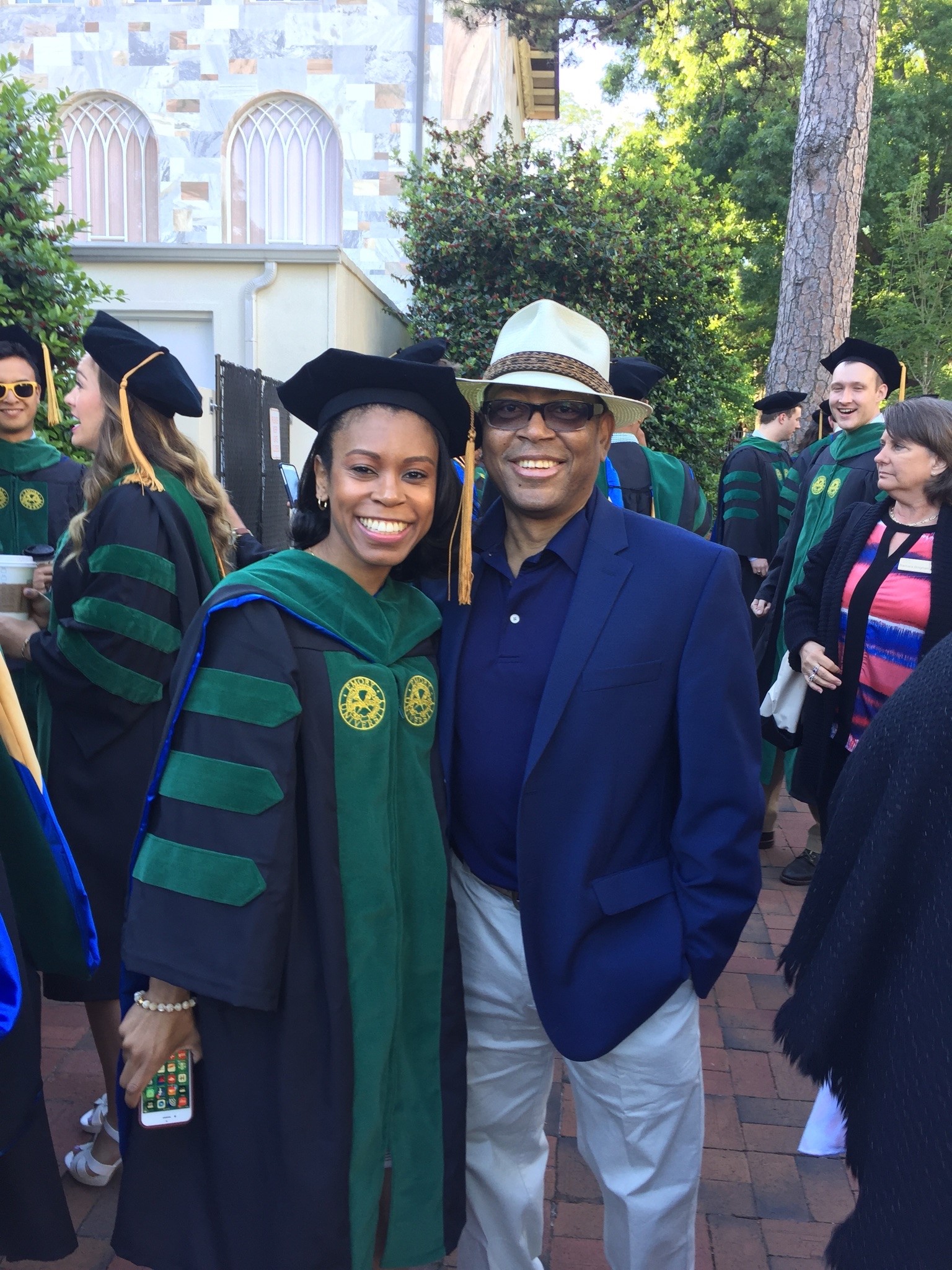 Mann pictured with his daughter at her graduation ceremony