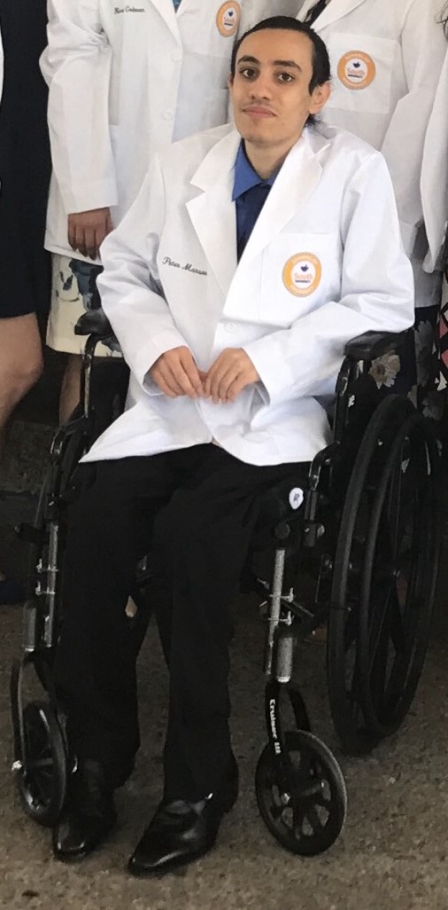 Peter wearing pharmacist white coat