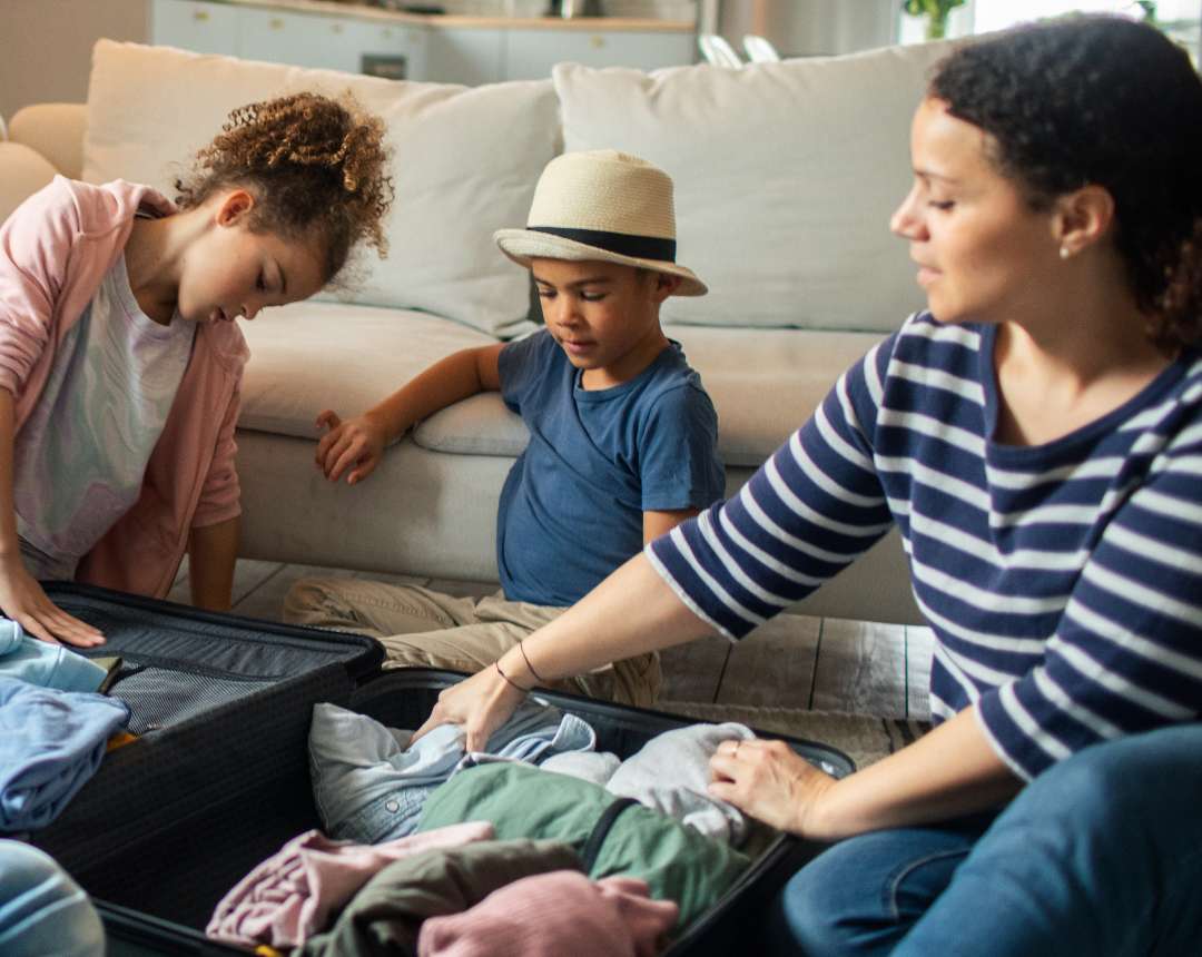 Family packing suitcase for a trip